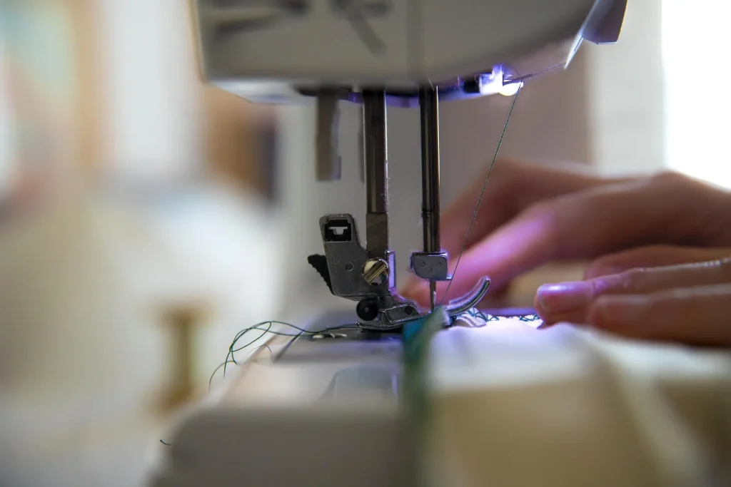 Close up image of someone using a sewing machine